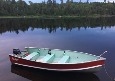 red aluminum boat on river