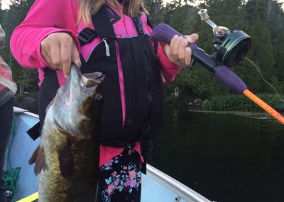 girl holding a big bass